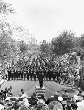 Photo of all-brass band marching down Main Street, U.S.A on June 14, 1959
