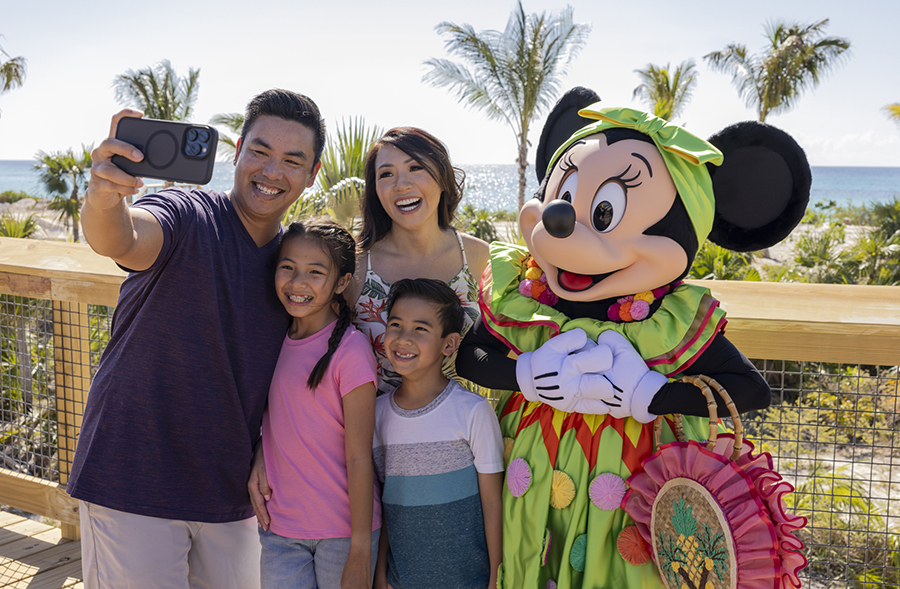 Minnie Mouse poses for a picture with guests at Disney Lookout Cay at Lighthouse Point