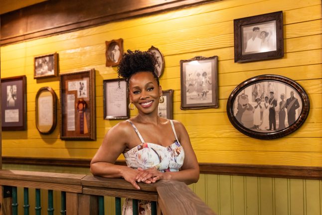 Anika Noni Rose smiles in the queue for Tiana's Bayou Adventure