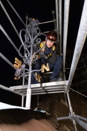Blacksmith Darryl Reeves installing a custom handcrafted weathervane 