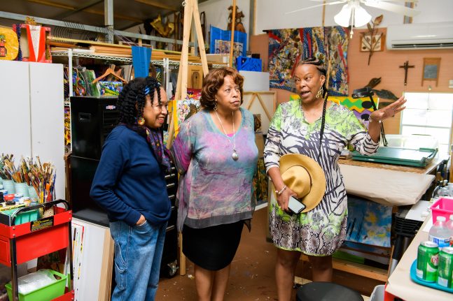 Carmen Smith, senior vice president, Creative Development - Product/Content & Inclusive Strategies,  fellow Imagineer Charita Carter and local artist Malaika Favorite discuss Tiana's Bayou Adventure
