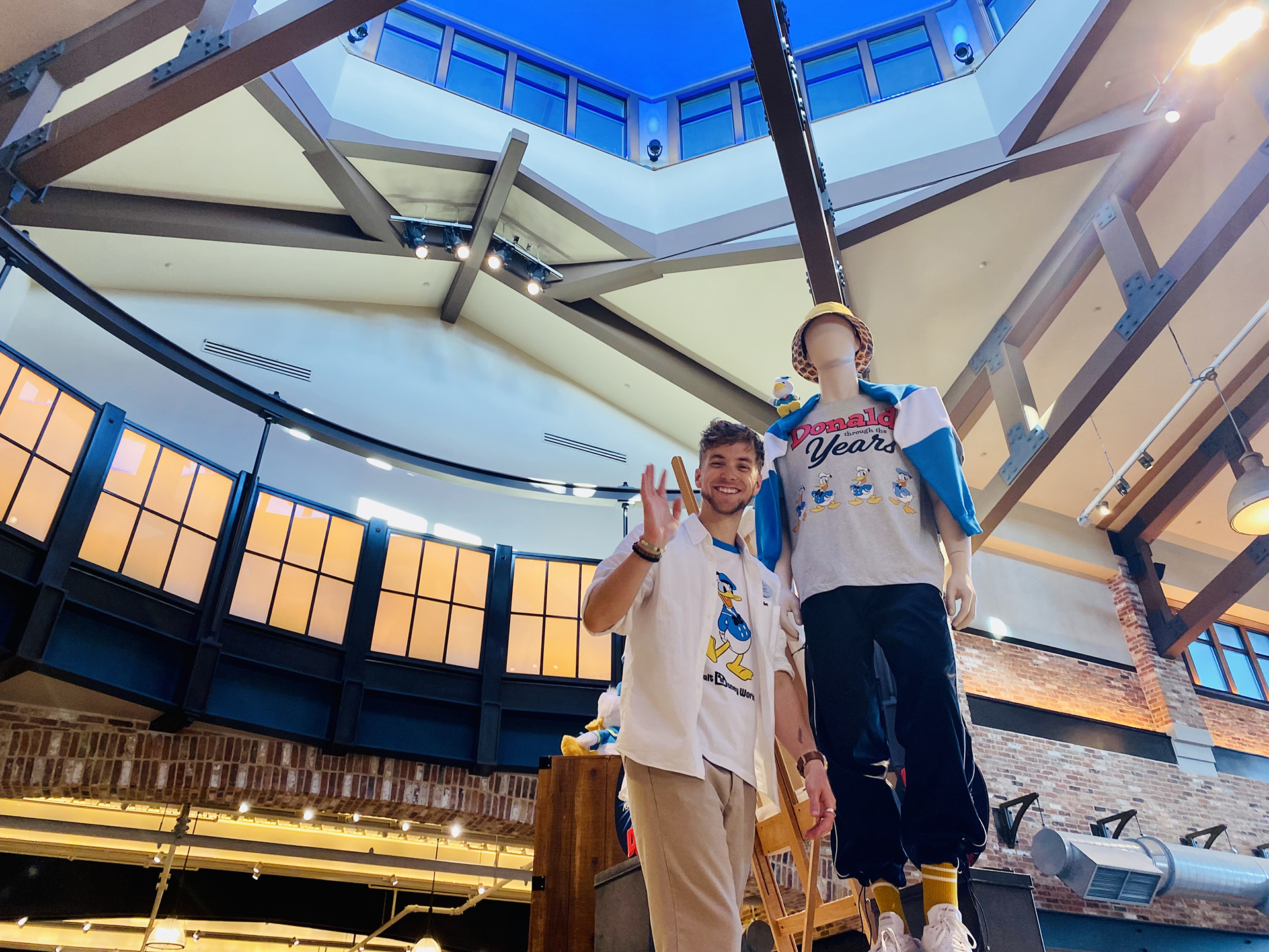 Jeffrey smiles in front of a Donald Duck merchandise display