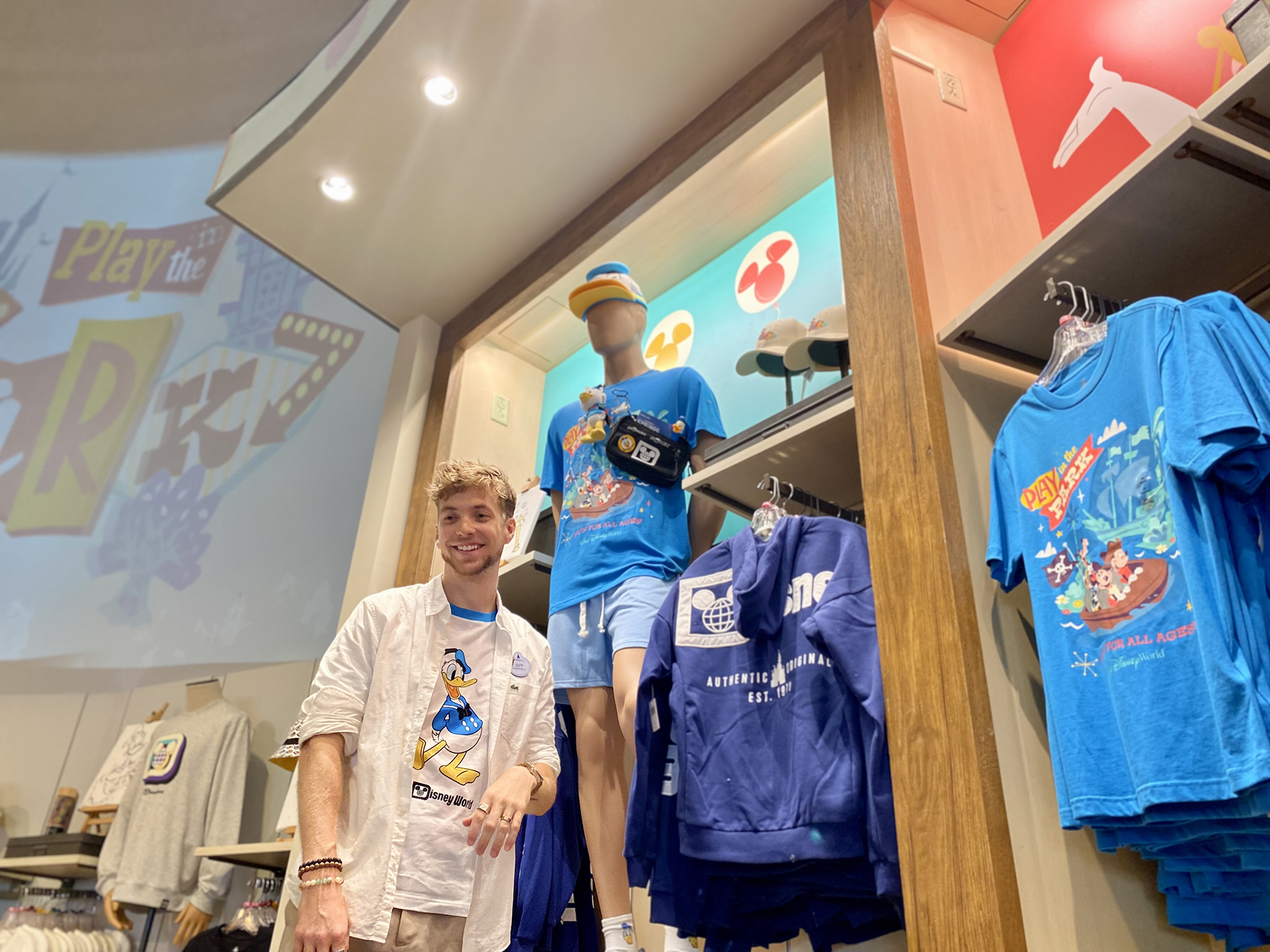 Jeffrey smiles in front of a Donald Duck merchandise display