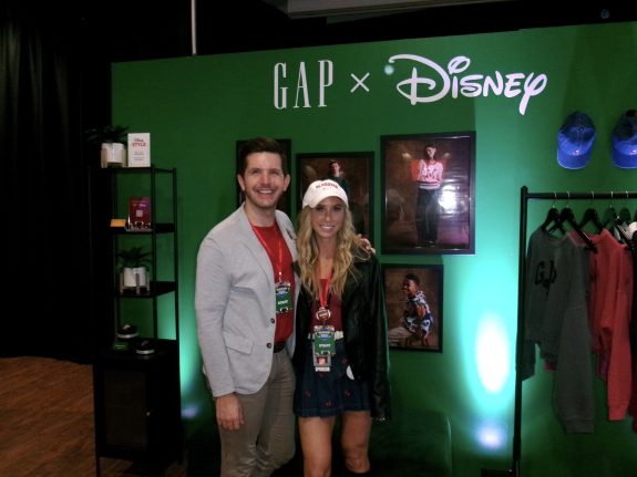 Alexis poses in front of a GAP x Disney backdrop in Big Moment for Disney Consumer Products