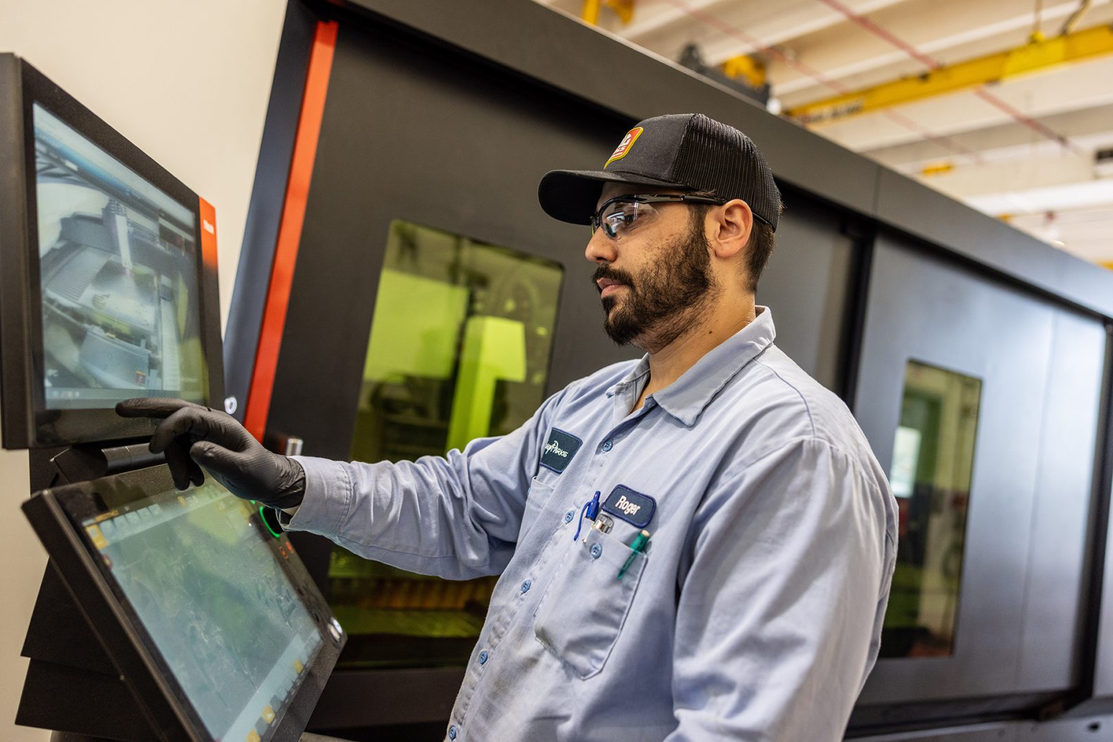 A Central Shops cast member works at digital display