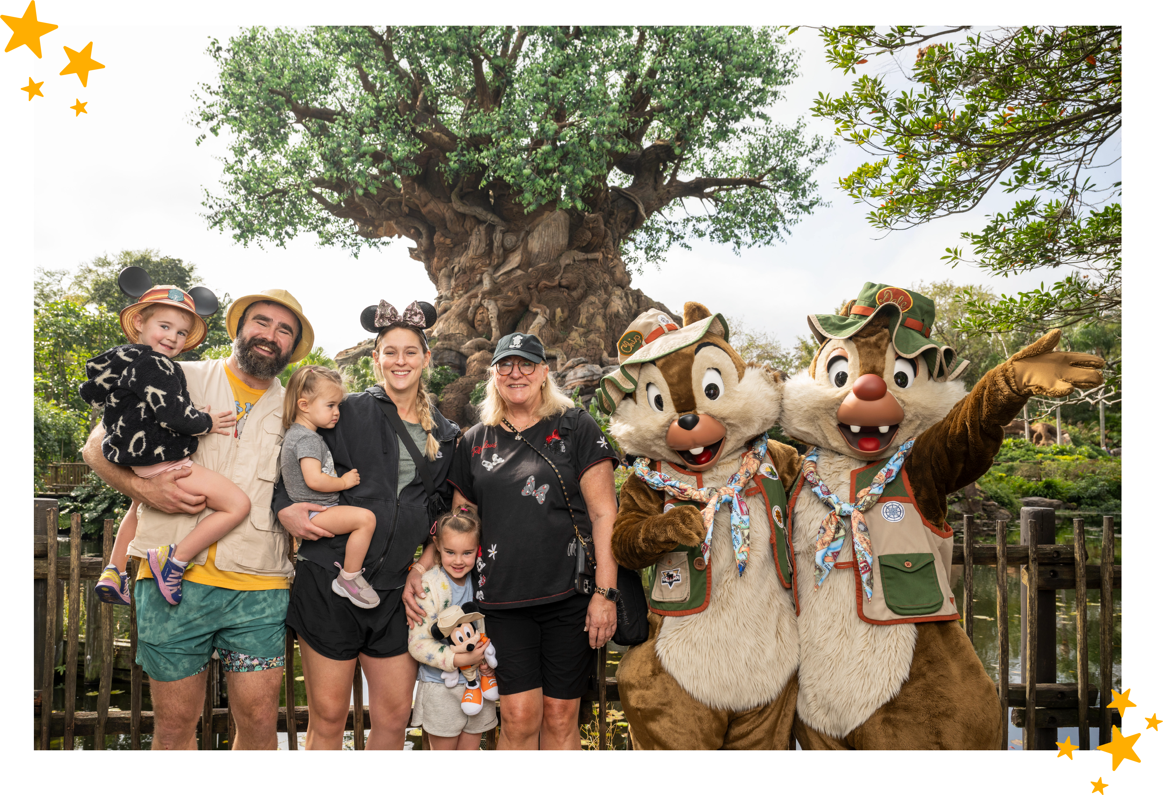 The Kelce Family posing in front of Disney's Animal Kingdom's Tree of Life with Chip & Dale.