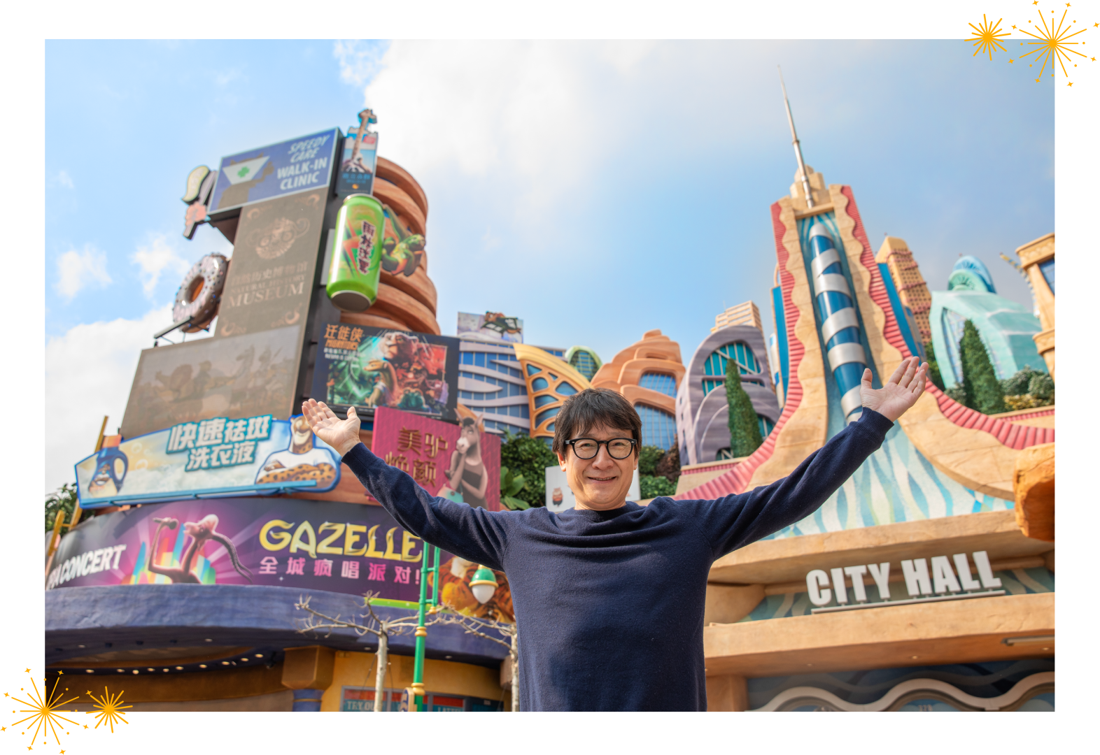 Ke Huy Quan raising his arms in front of Zootopia: Hot Pursuit at Shanghai Disney Resort.