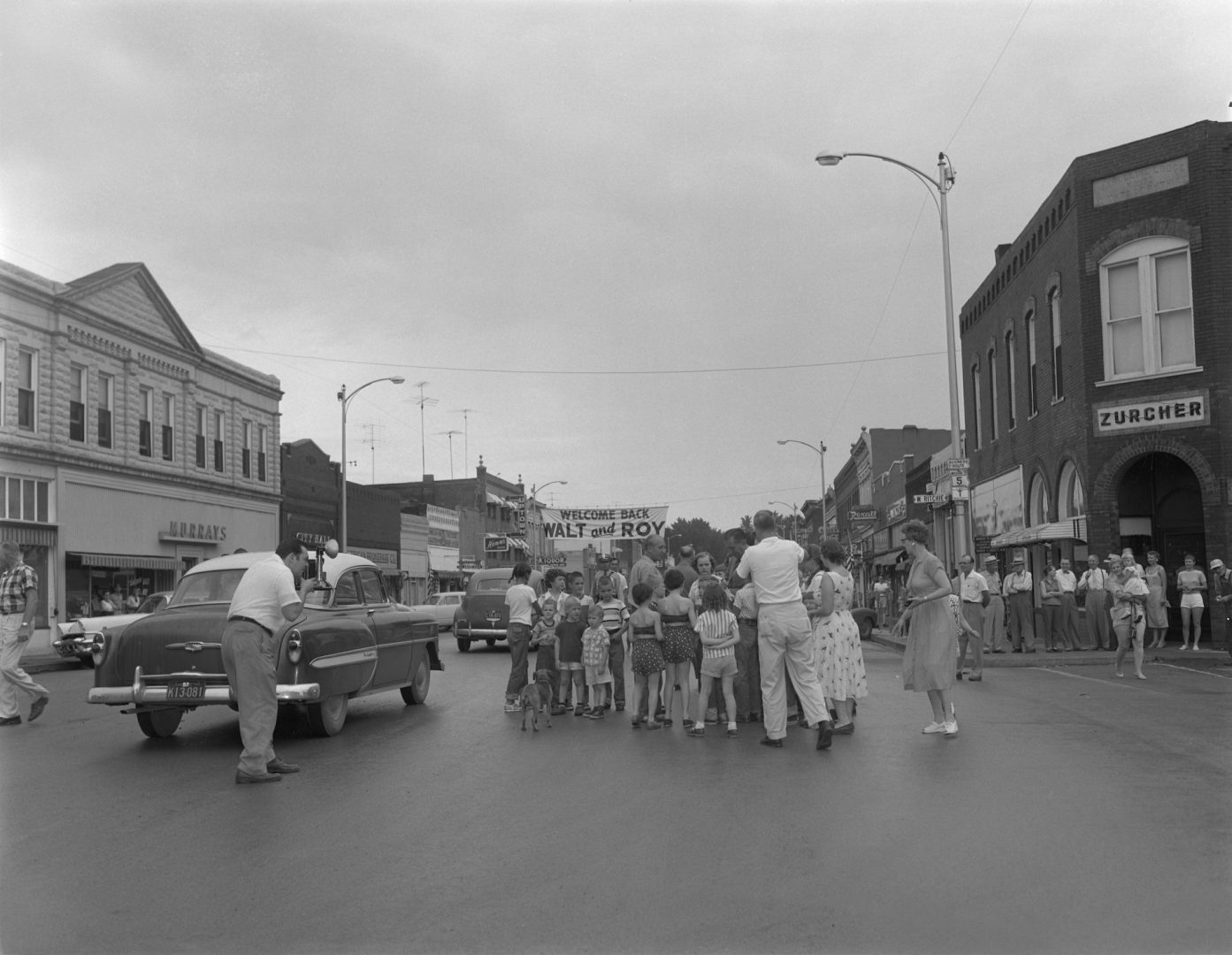 Walt Disney with fans in the streets of Marceline