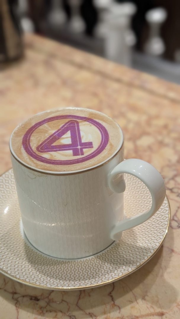 Latte art with purple Fantastic Four logo