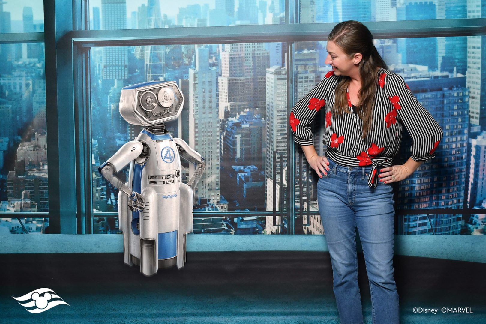 Woman posing for DCL Magic Shot with H.E.R.B.I.E