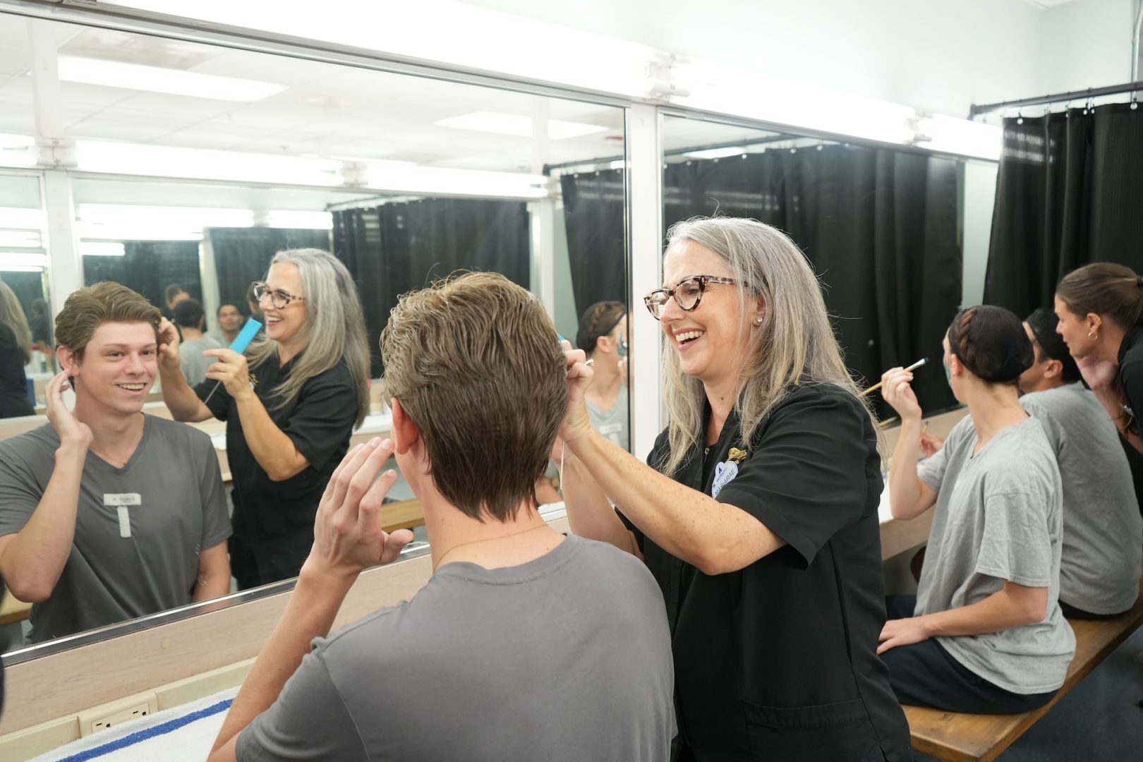 Mariarae, Cosmetology Coordinator prepping wigs in the dressing room
