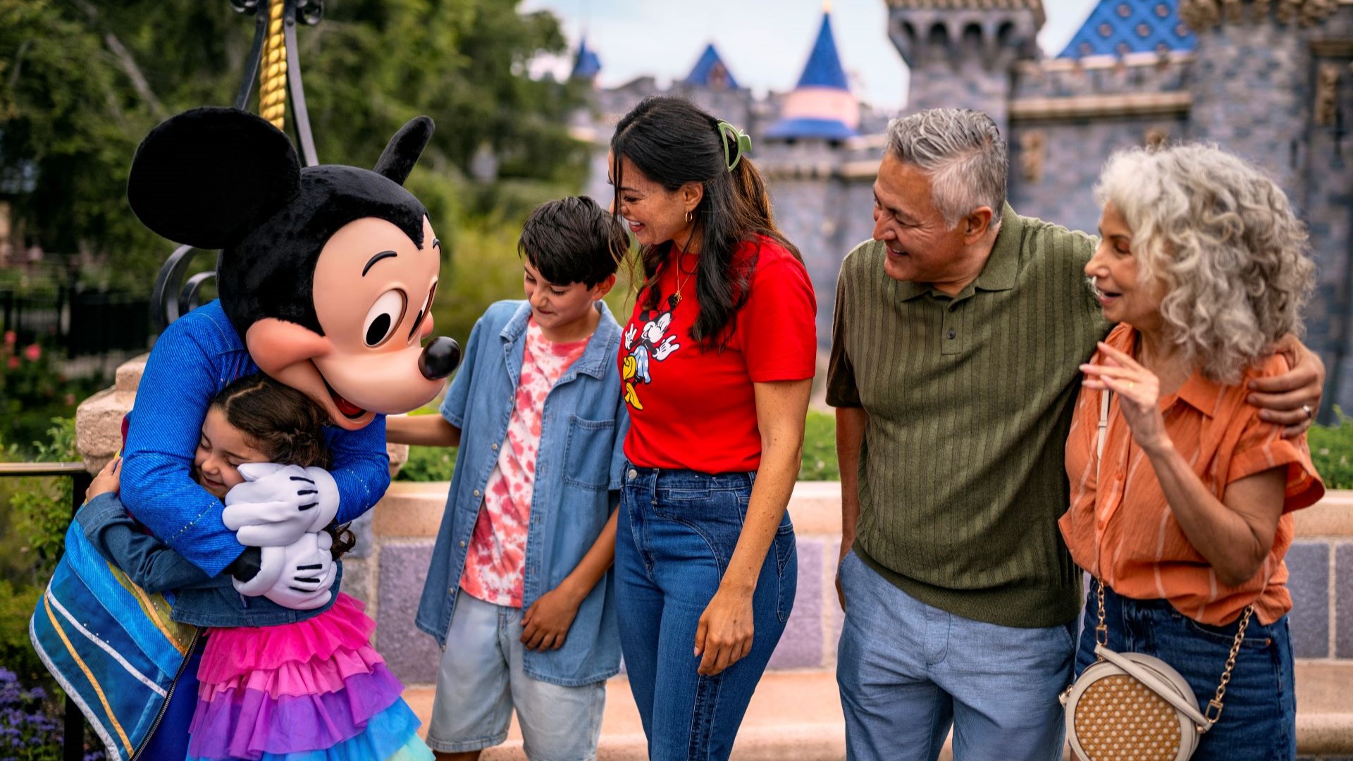 Family Visiting Disneyland Park with Mickey Mouse