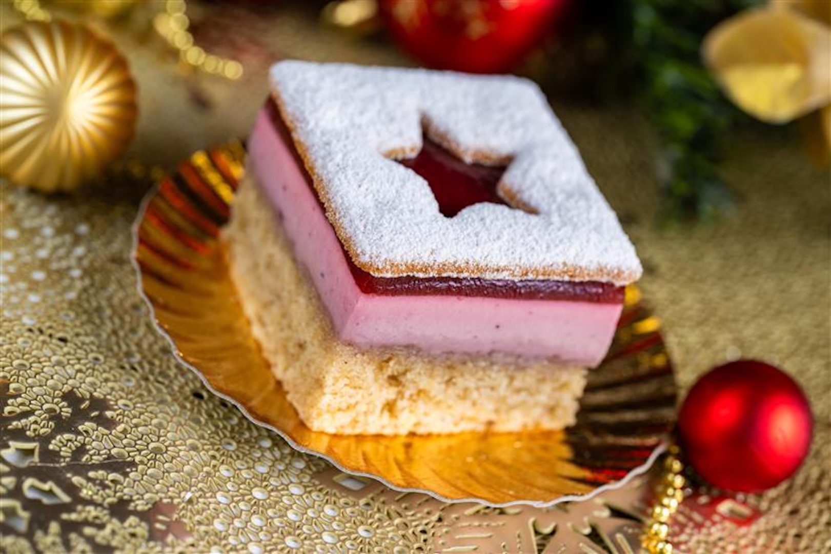 Linzer Cookie Mousse Torte: Layers of hazelnut cake, raspberry-blackcurrant mousse, raspberry jam, and sweet snow-dusted linzer cookie 