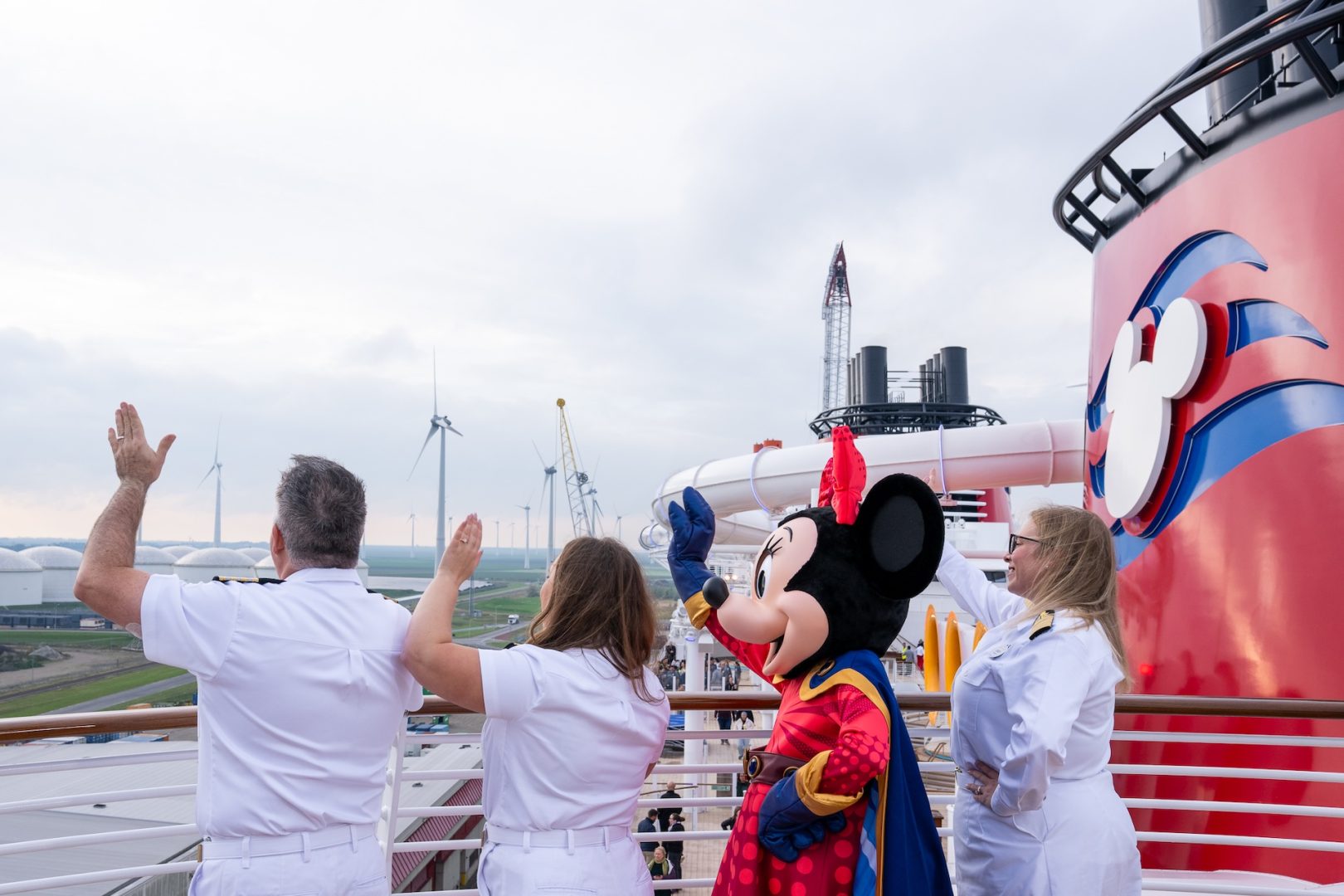 Crew members and Minnie Mouse during the Disney Destiny crossing