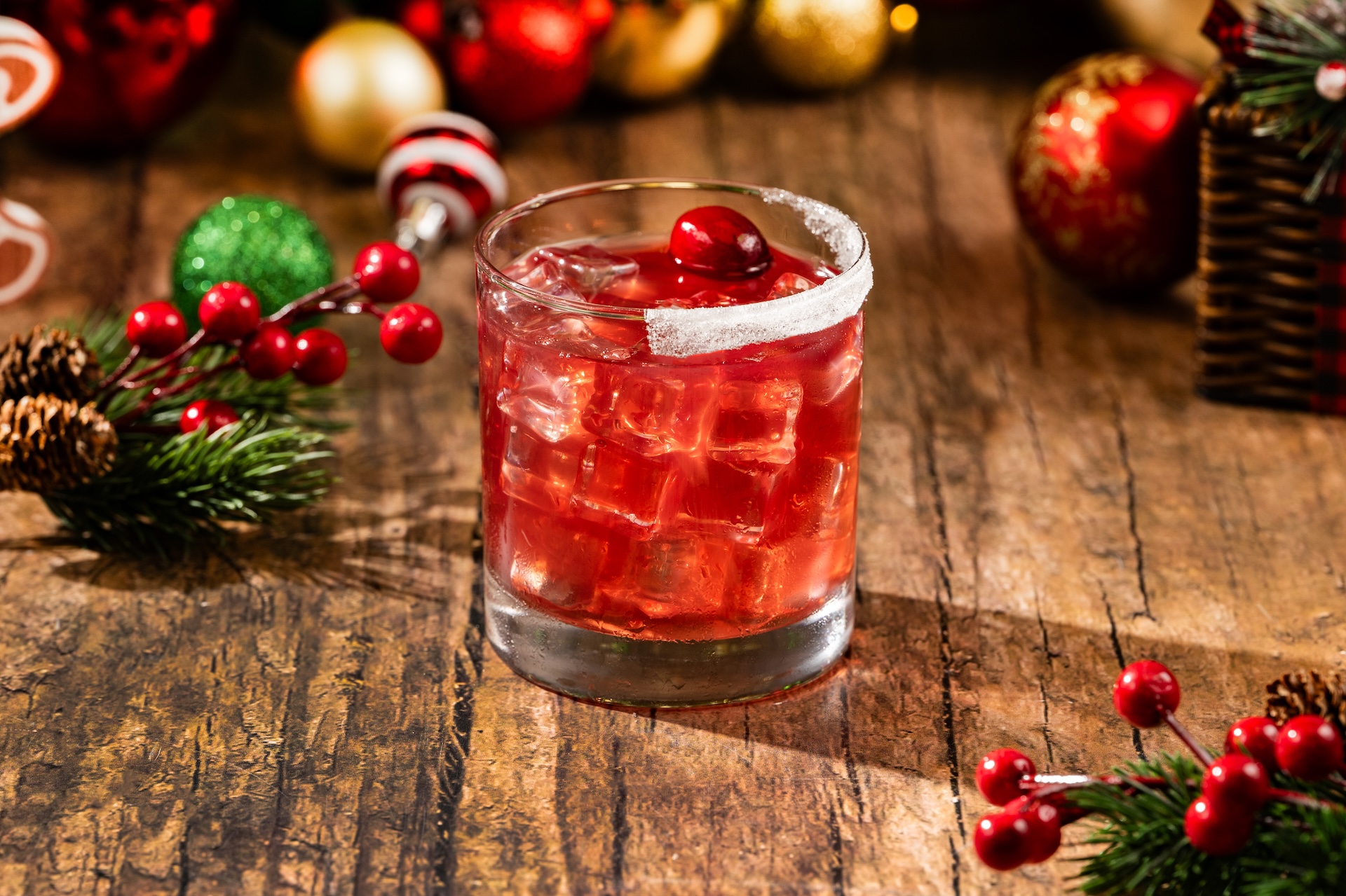Mistletoe Margarita: Teremana Blanco Tequila, Grand Marnier Liqueur, cranberry juice, and lime juice garnished with a sugared rim and cranberries