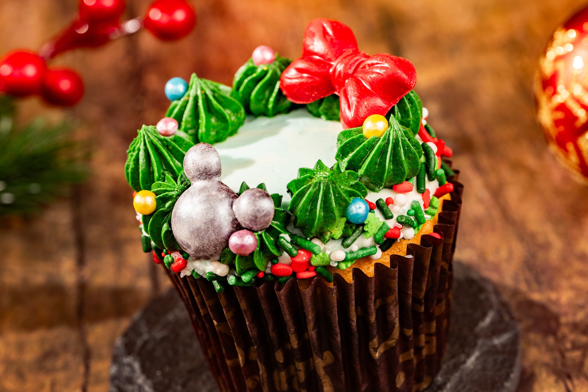 Christmas Wreath Cupcake: Peppermint confetti cupcake filled with chocolate ganache and topped with marshmallow buttercream and chocolate décor