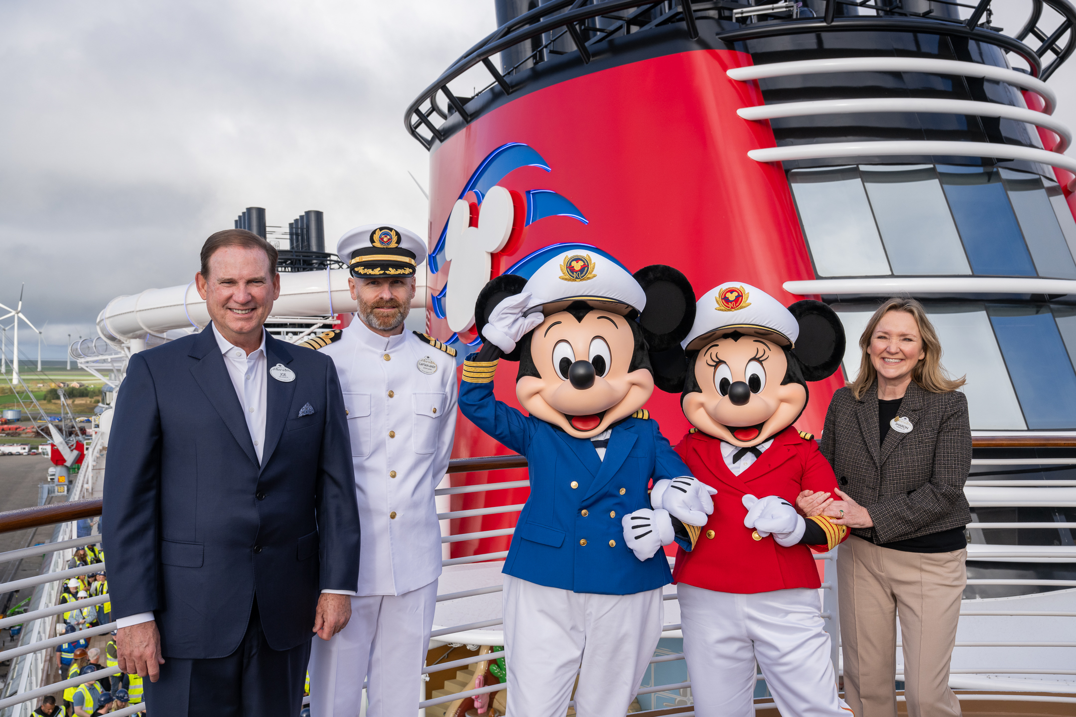 Joe Schott, president of Disney Signature Experiences, Sharon Siskie, senior vice president and general manager of Disney Cruise Line, and Captain Andy McRonald with Mickey and Minnie
