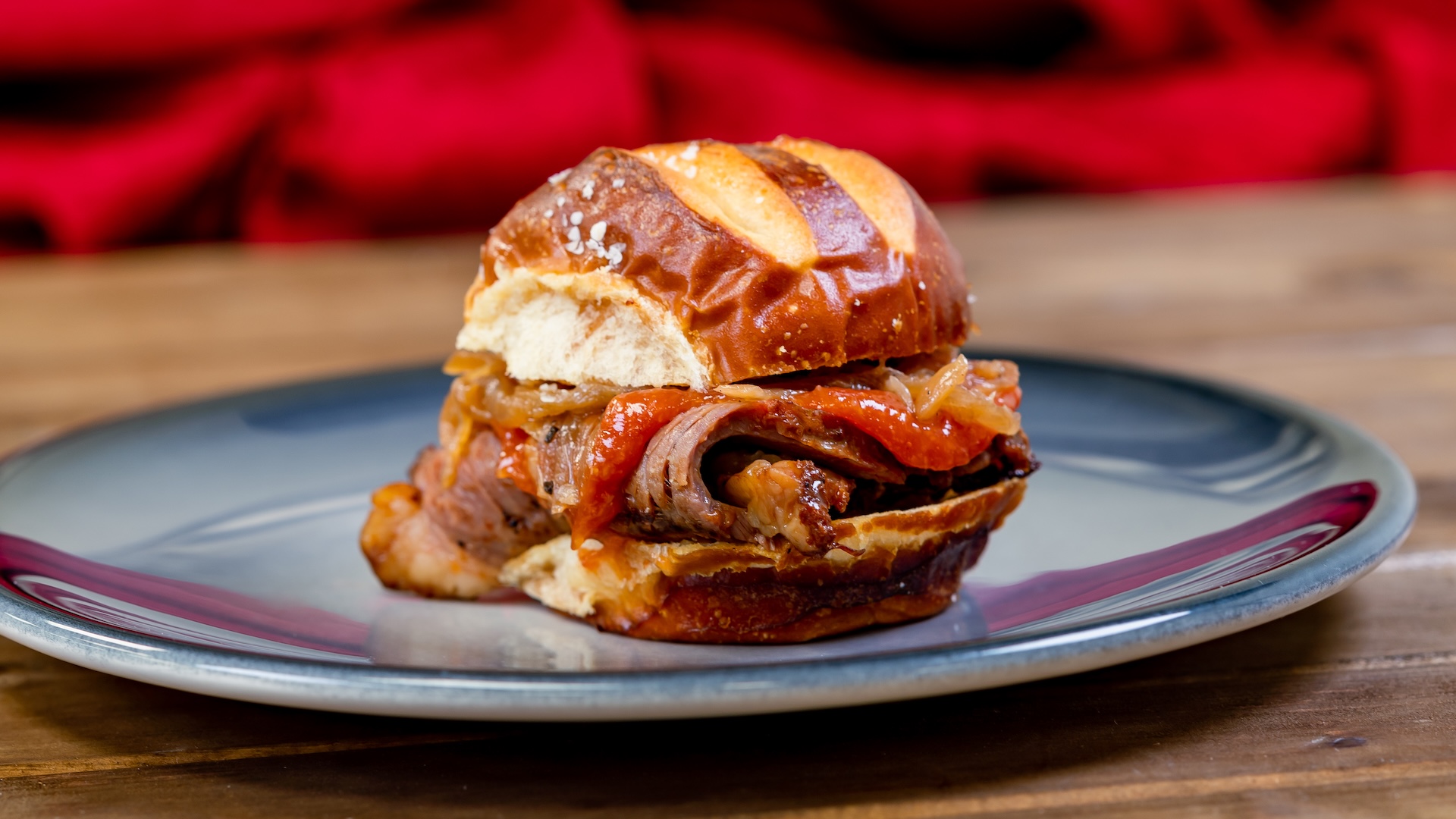 Beef Brisket Slider with smoked onions and horseradish ketchup on a pretzel roll