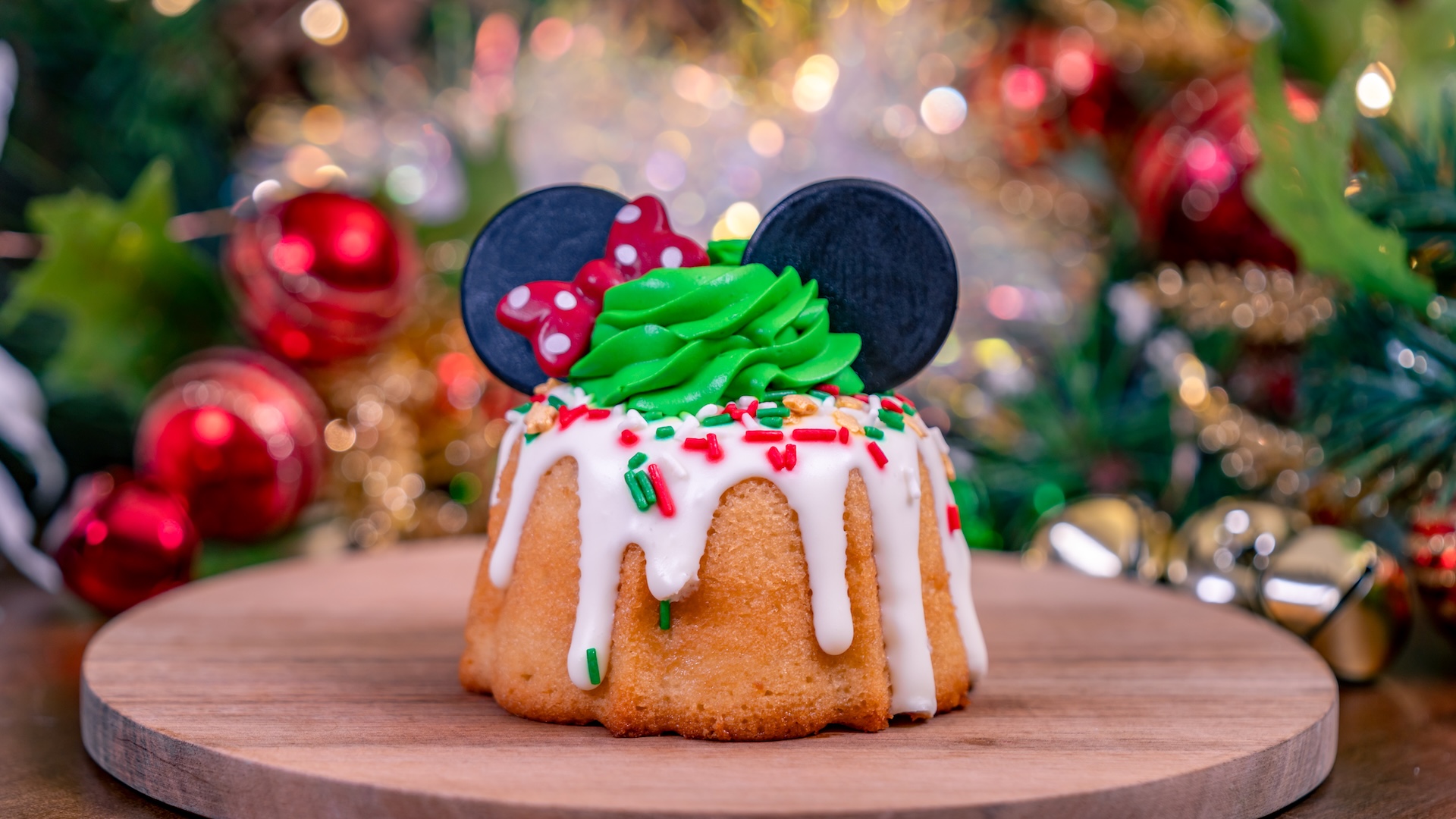 Apple Bundt Cake filled with caramelized apples, topped with cream cheese glaze and green mousse, and finished with chocolate ears and a red bow