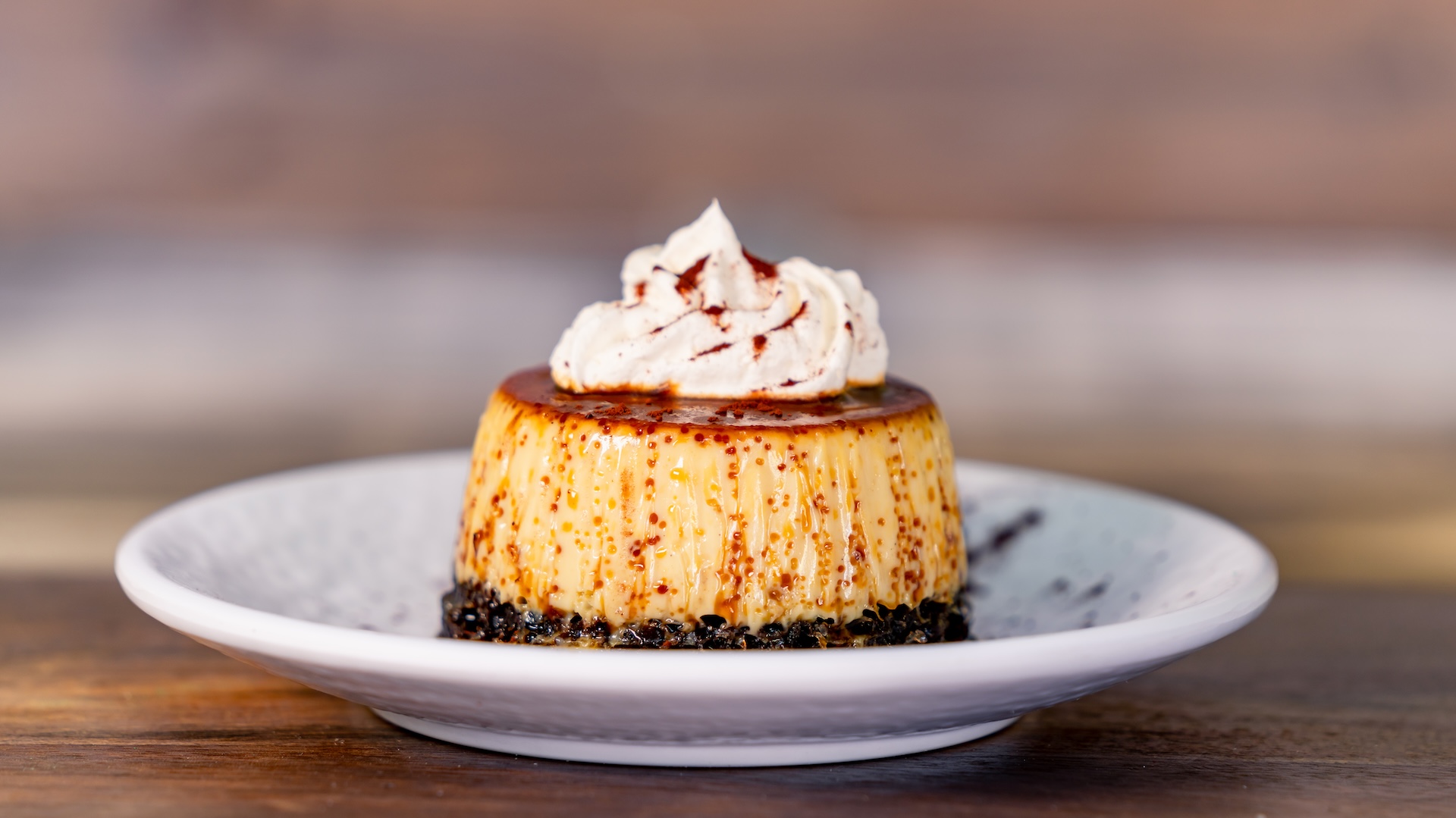 Chocolate Cake Flan: Chocolate cake and flan topped with caramel sauce, whipped cream, and cinnamon dust 
