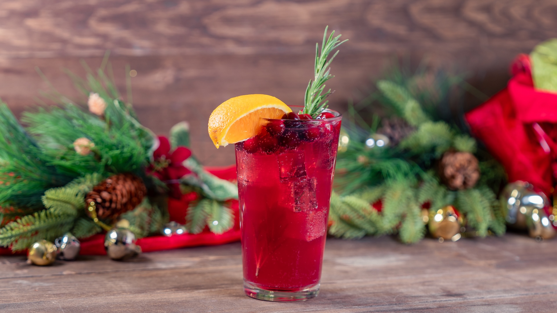 Holiday Punch: Pomegranate, cranberry, and orange juices and Sprite, garnished with cranberries, orange wedge, and a rosemary sprig (Non-alcoholic) 