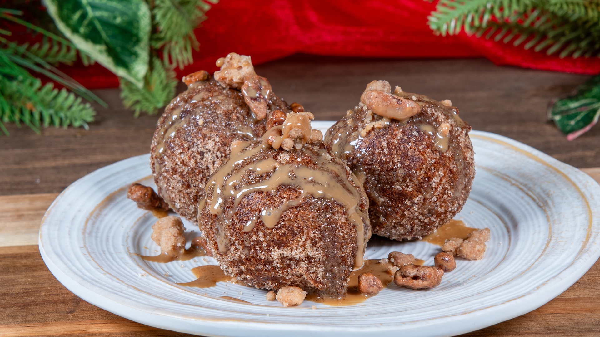 Coffee Fritters rolled in cinnamon sugar, drizzled with white mocha sauce, and garnished with praline sugar streusel 