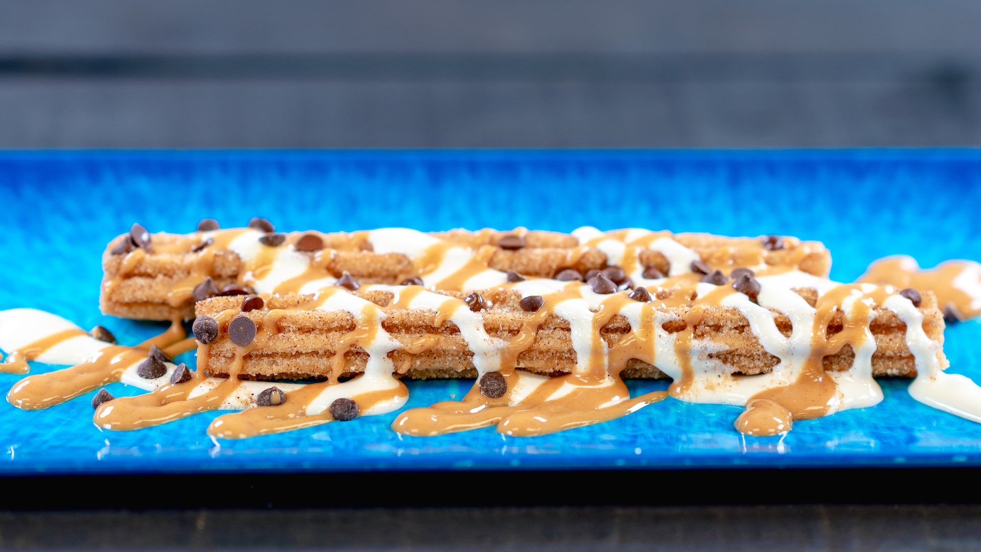 Fluffernutter Churro: Classic churro with peanut butter sauce, marshmallow sauce, and chocolate chips  
