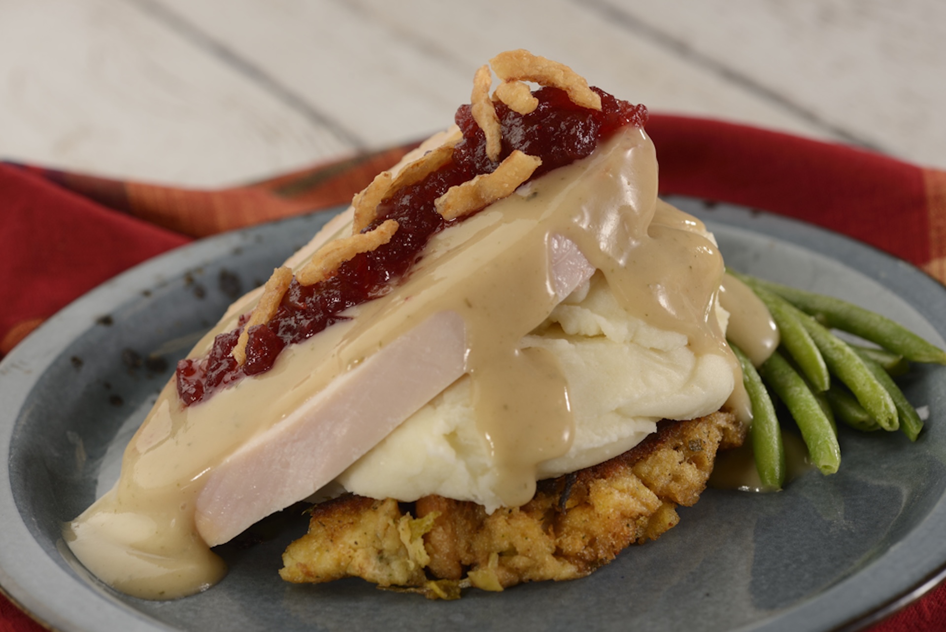 Slow-roasted Turkey with stuffing, mashed potatoes, green beans, and cranberry sauce