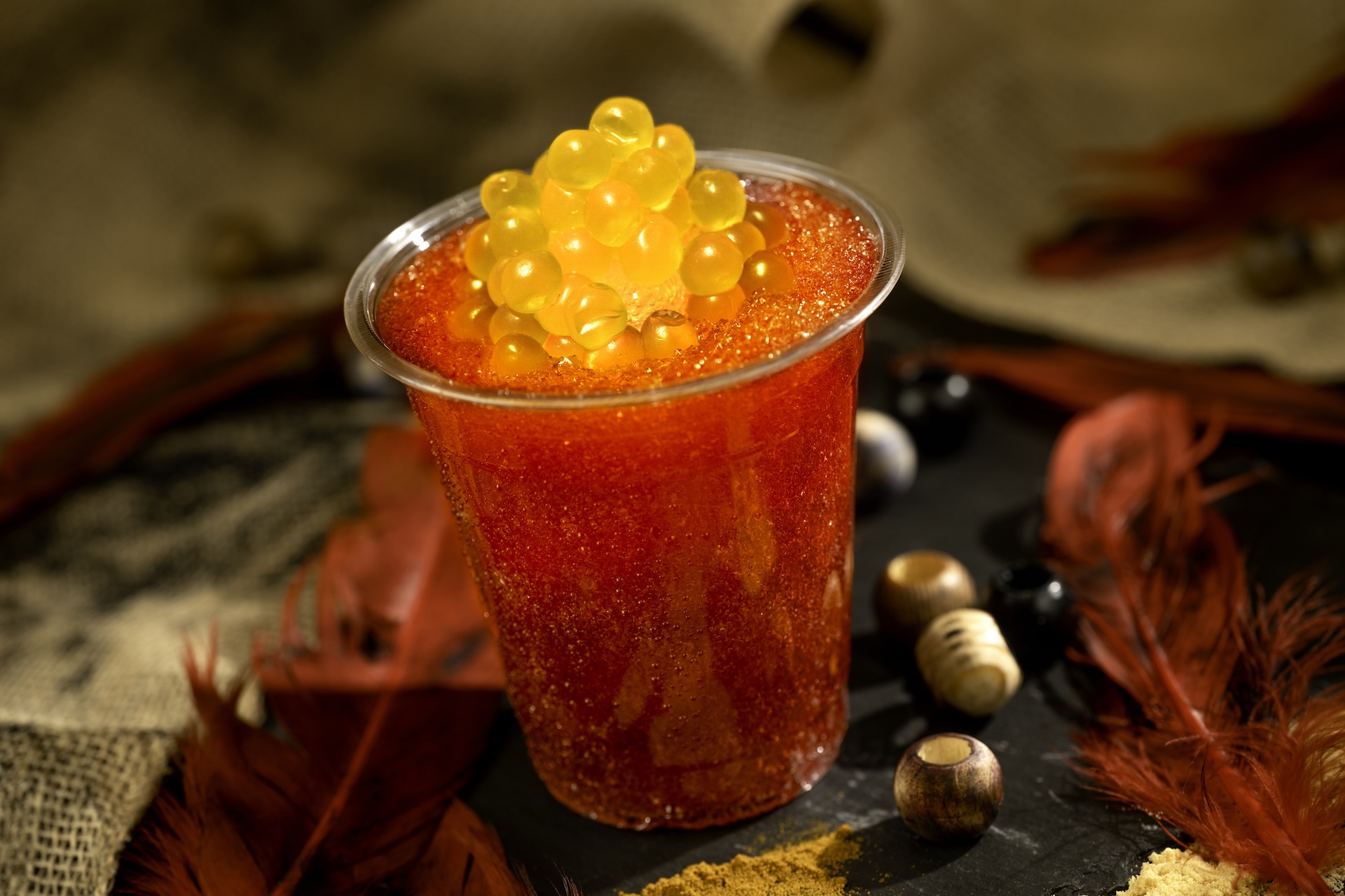 Nightwraith Blaze: Blood orange, lychee, and wildberry slushy topped with a glow cube and passion fruit juice-filled pearls (also available with a float of Tito's Handmade Vodka) 