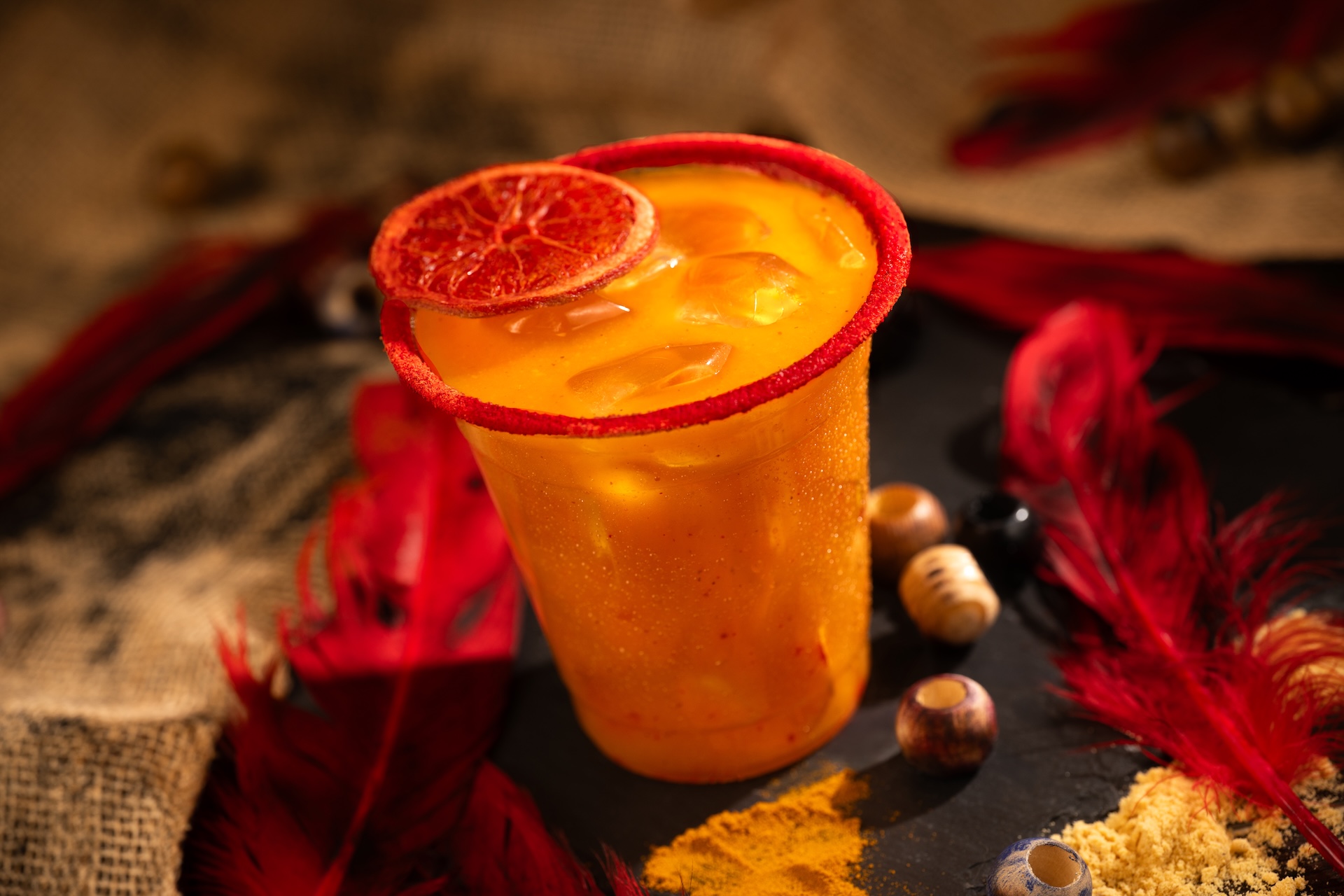 Trader’s Tailwind: Captain Morgan Original Spiced Rum, Bols Triple Sec Liqueur, mango purée, Minute Maid Orange Juice, chamoy, and ginger beer with a chili-lime-rimmed glass garnished with a dehydrated blood orange wheel 