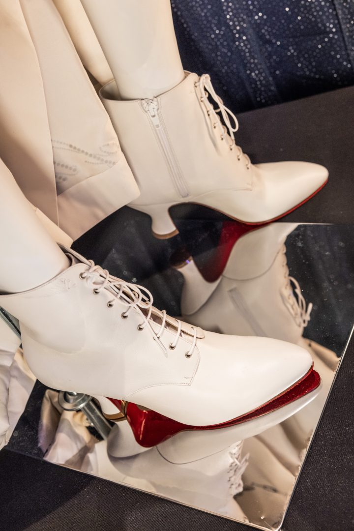 Taylor Swift THE TORTURED POETS DEPARTMENT” shoes on display at Disney World