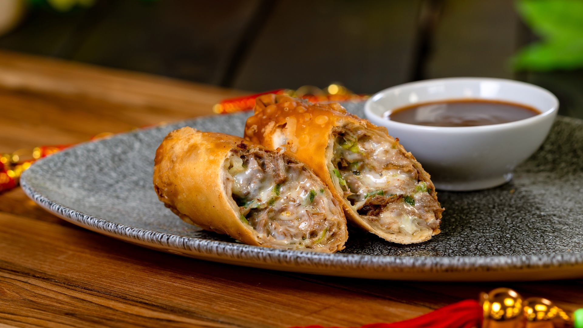Quesabirria Eggroll with guajillo pepper consomé