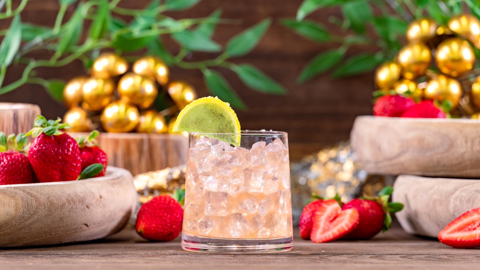 Strawberry Lychee Cocktail: Bourbon, strawberry purée, lychee syrup, and lime juice garnished with a lime gummy wedge