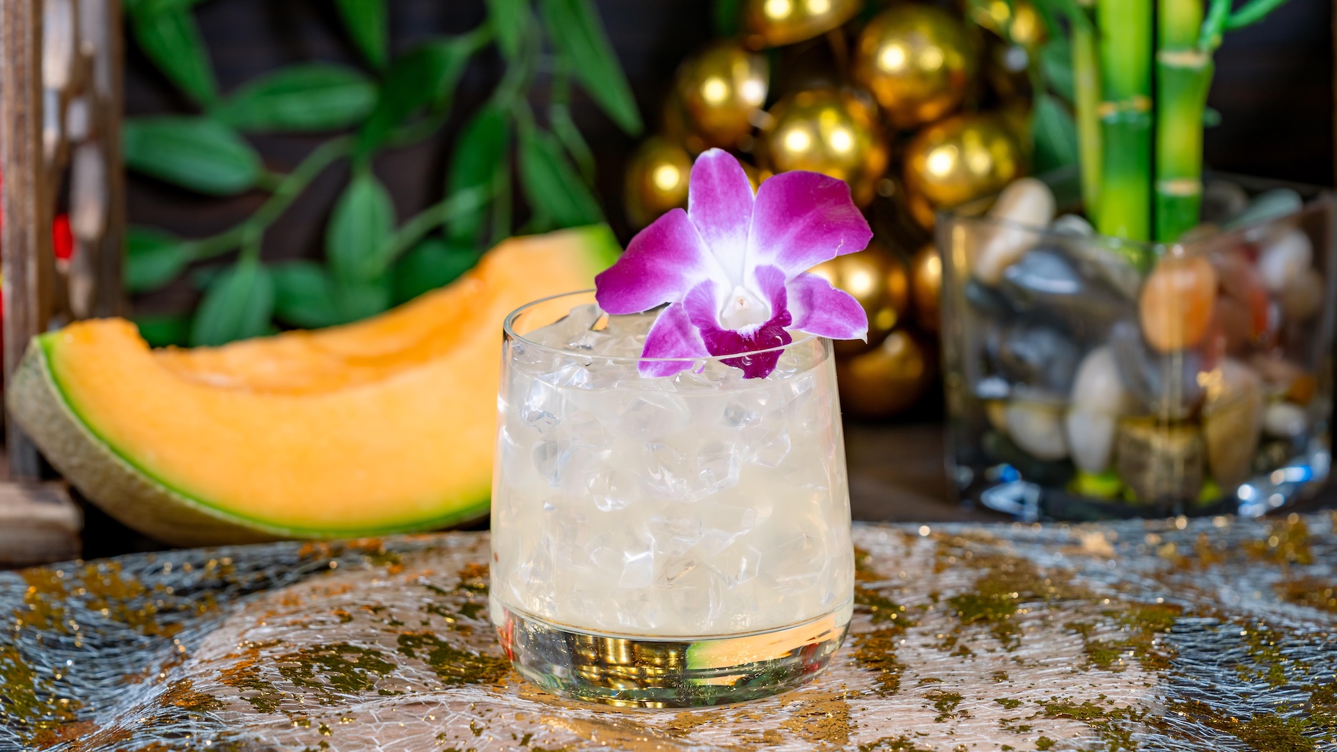 Yuja-Melon Cocktail: Gin, Lillet Blanc, yuja purée, and rock melon syrup garnished with a purple orchid (New)