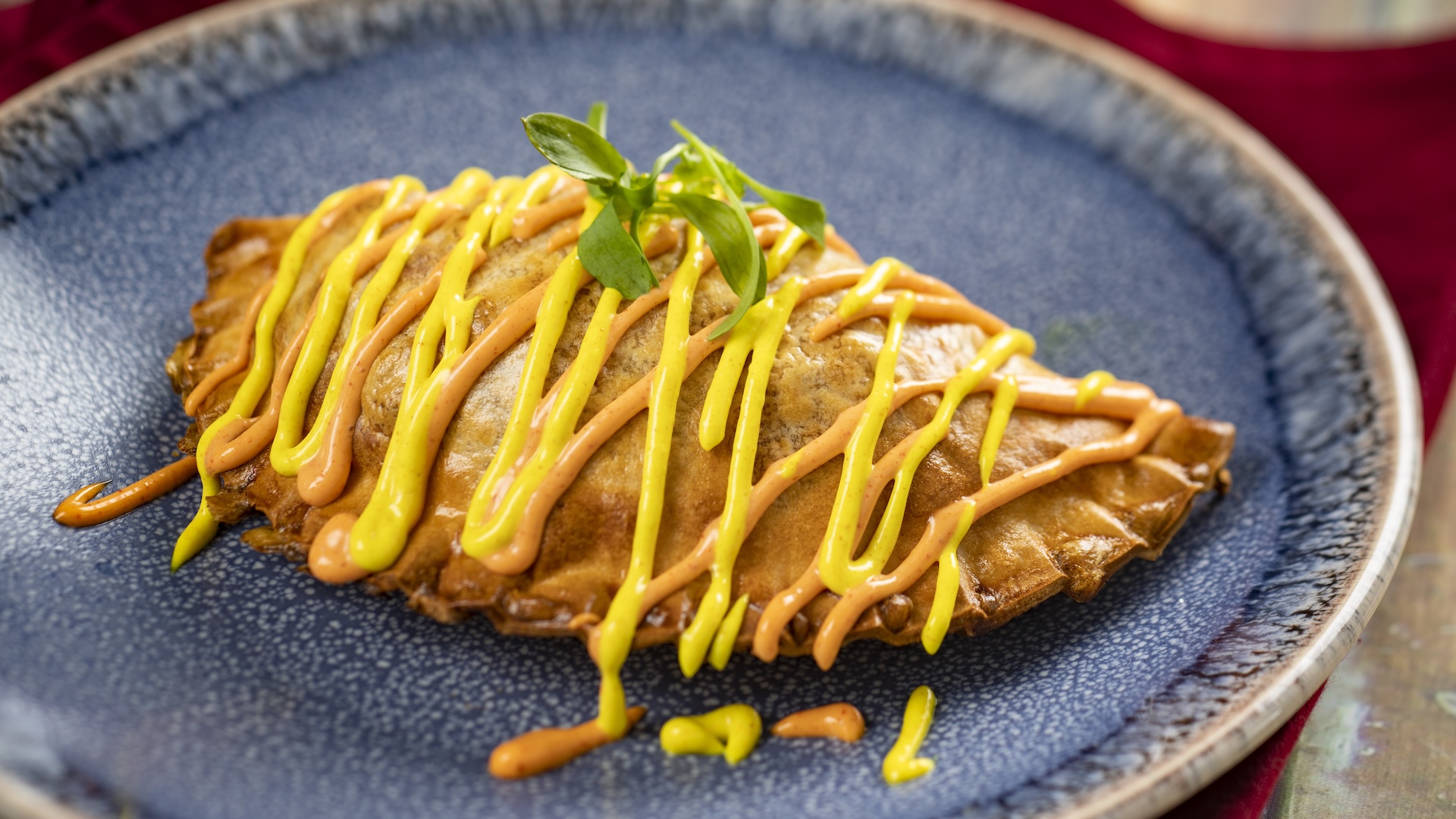 Chorizo and Potato Empanada with turmeric aïoli and annatto aïoli