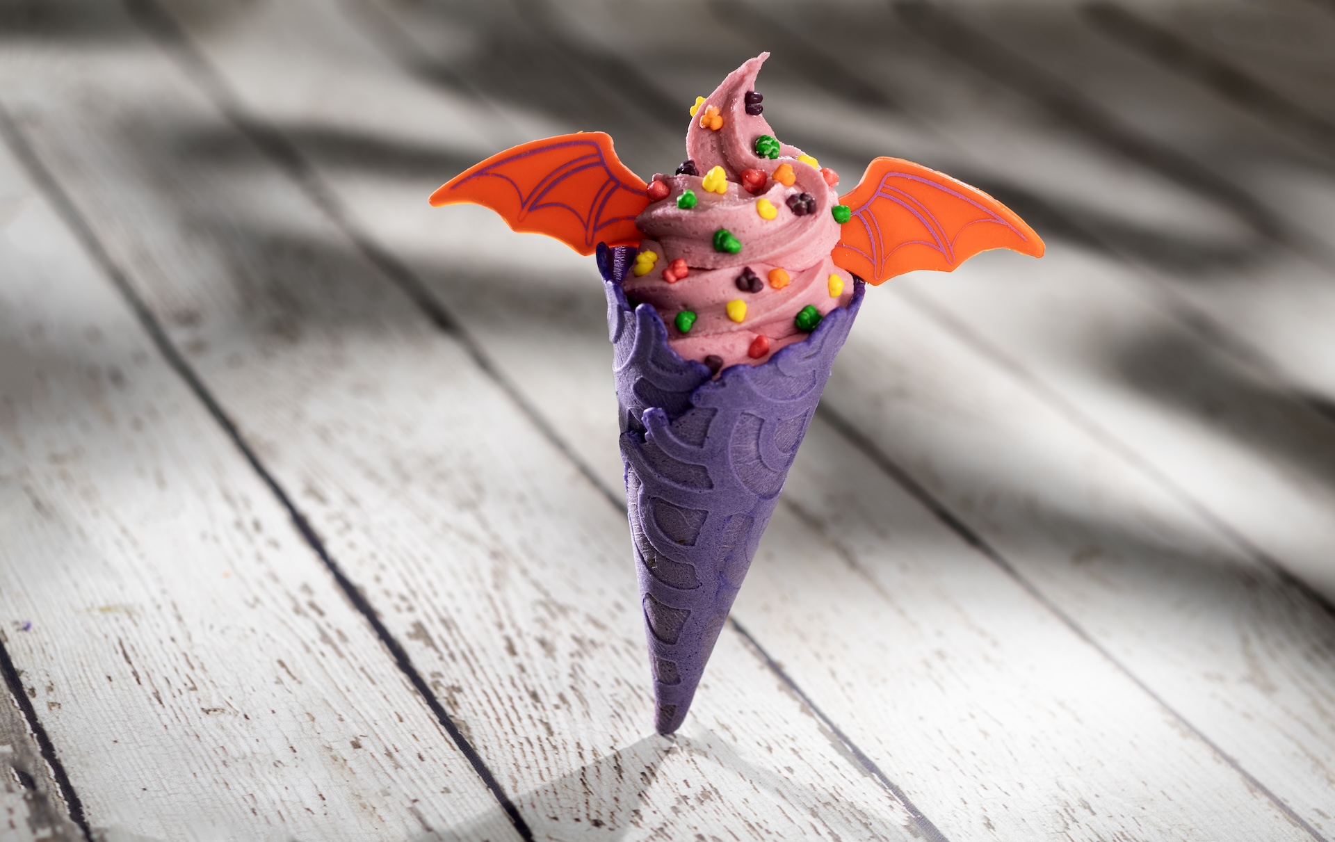 Imagination Cone: Pink vanilla soft-serve in a lavender cone, “sparks” of imagination, and white chocolate Figment wings