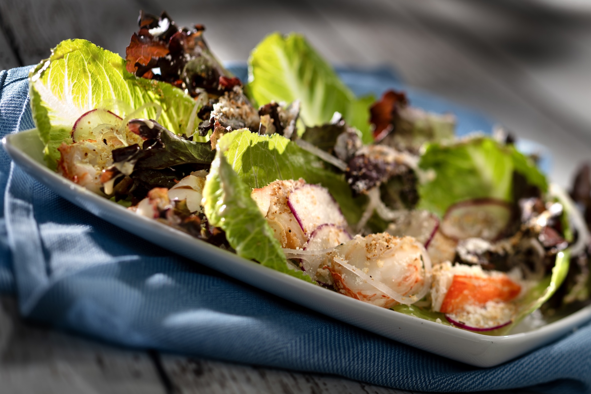 Steakhouse Lobster Caesar Salad with romaine and red oak lettuces, warmwater lobster, radish, herbed breadcrumbs, and house-made Caesar dressing (New)