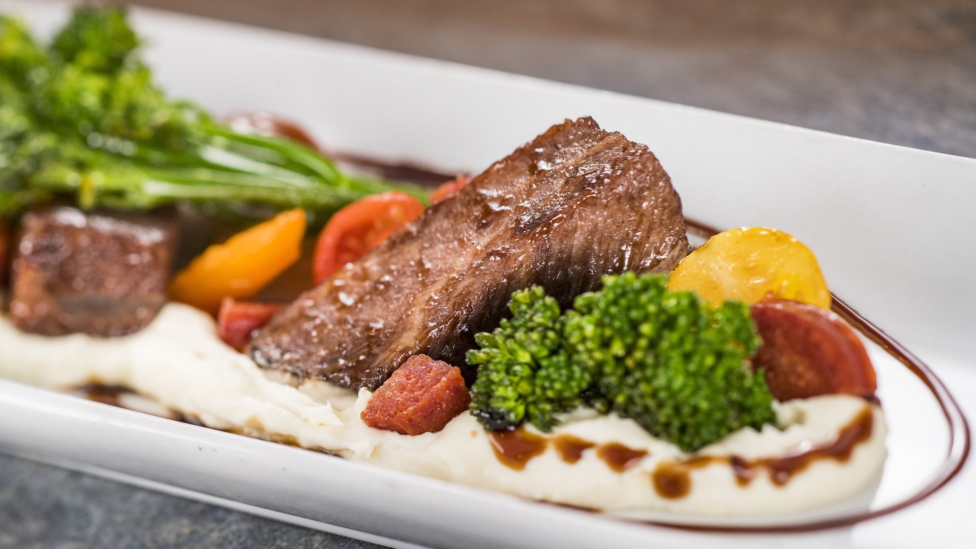 Red Wine-braised Beef Short Rib with parsnip purée, broccolini, baby tomatoes, and balsamic glaze